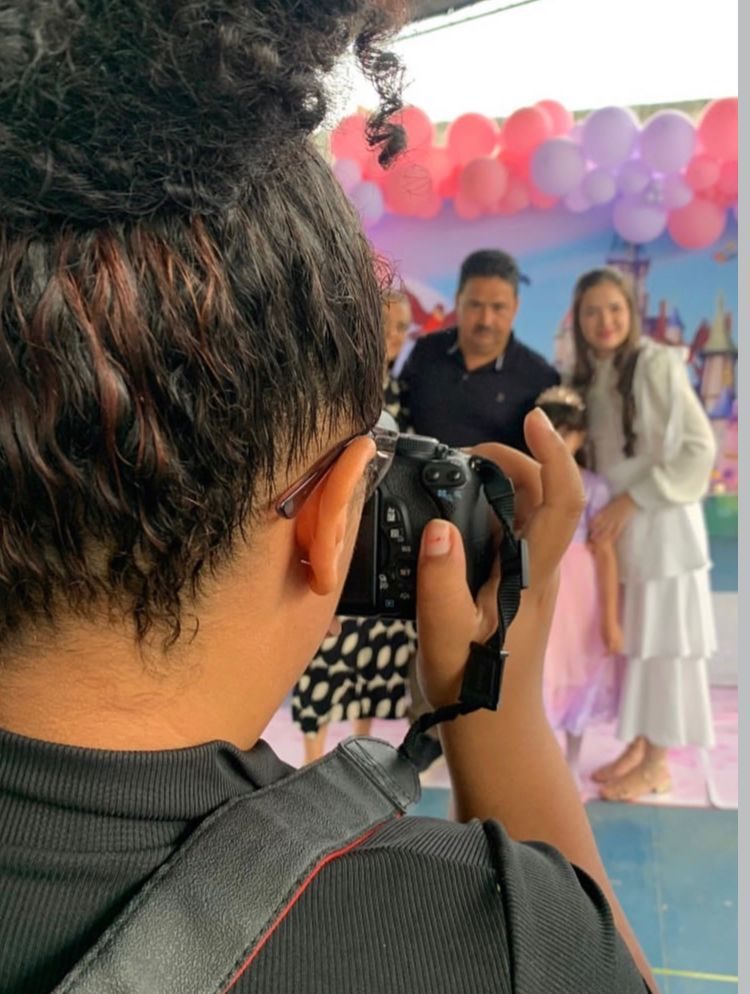 Photographer taking a photo in a mountain landscape at sunset
