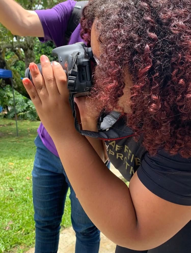Professional woman photographer holding a camera looking confident